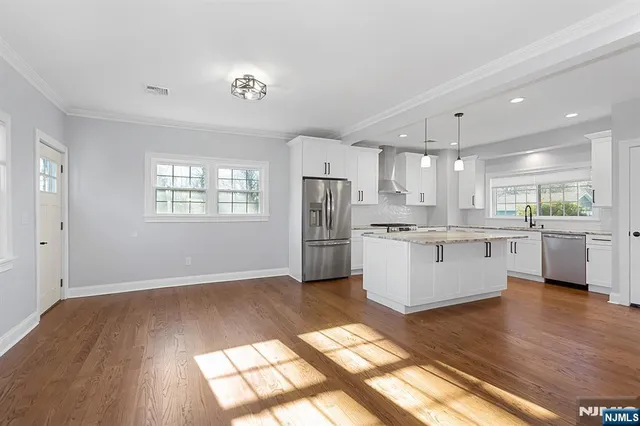 a view of kitchen with wooden floor and electronic appliances
