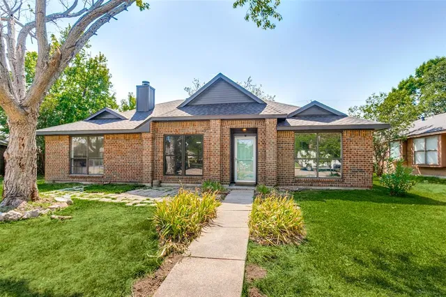 a front view of a house with a yard and porch