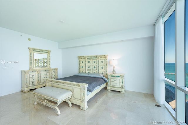 a bedroom with a bed and windows