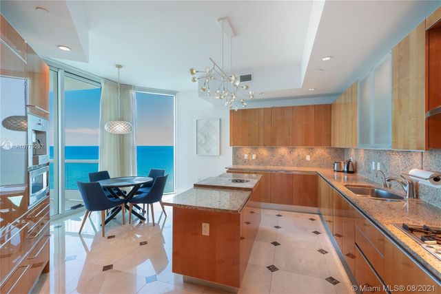 a kitchen with granite countertop a sink stove and cabinets