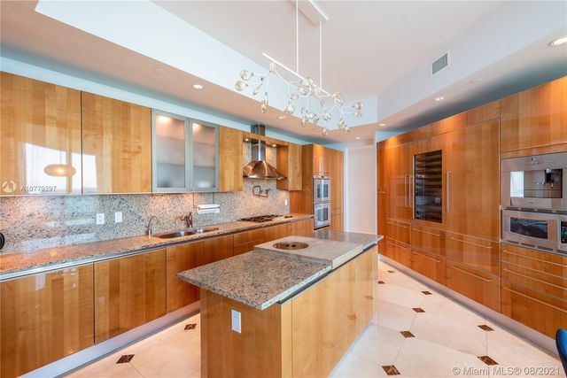 a kitchen with granite countertop a sink and stove