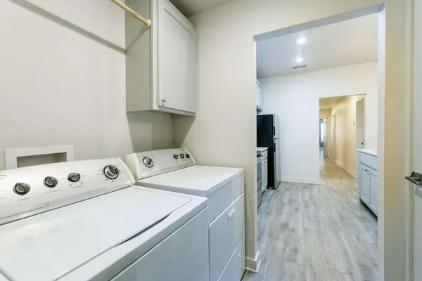 a view of washer and dryer with wooden floor