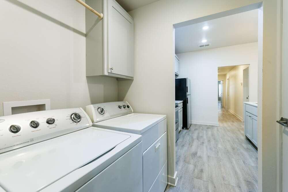 5542 Lehigh Street Lubbock, TX 79416 - Photo 11 of 12 a view of washer and dryer with wooden floor
