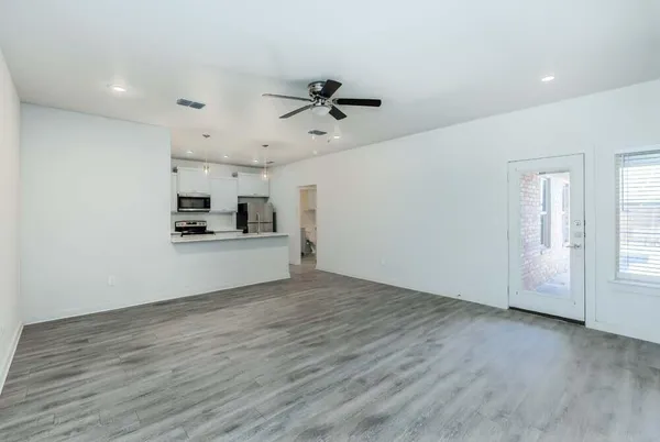 a view of a kitchen with a sink cabinets and wooden floor
