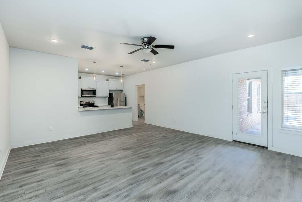 5542 Lehigh Street Lubbock, TX 79416 - Photo 4 of 12 a view of a kitchen with a sink cabinets and wooden floor