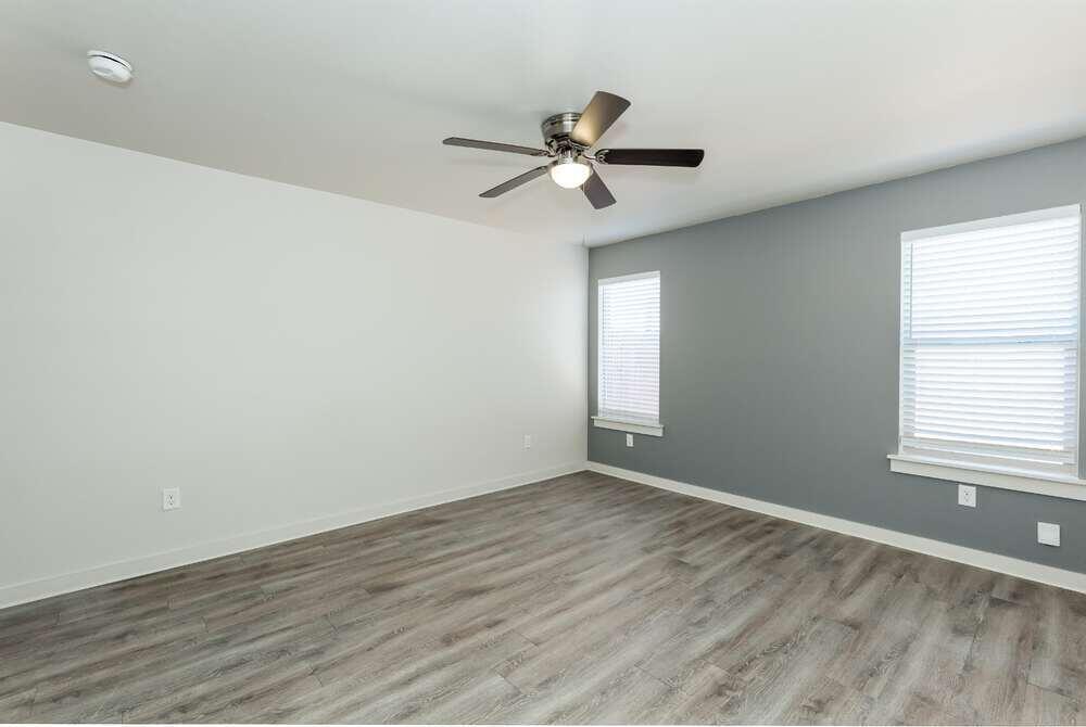 5542 Lehigh Street Lubbock, TX 79416 - Photo 7 of 12 a view of empty room with wooden floor and fan