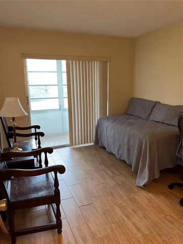 a bedroom with a bed and a chair