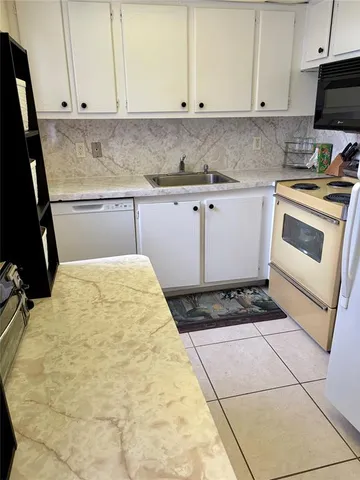 a kitchen with a stove a sink and a microwave