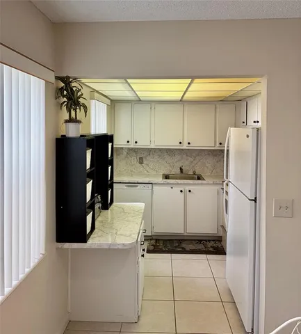 a kitchen with a refrigerator and a stove