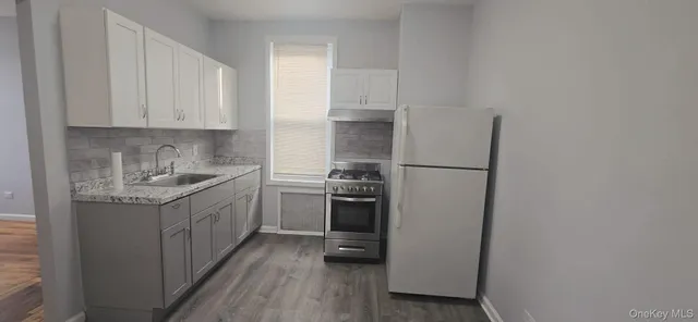 a kitchen with stainless steel appliances granite countertop a refrigerator sink and stove