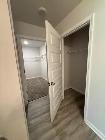 a view of walk in closet with empty racks