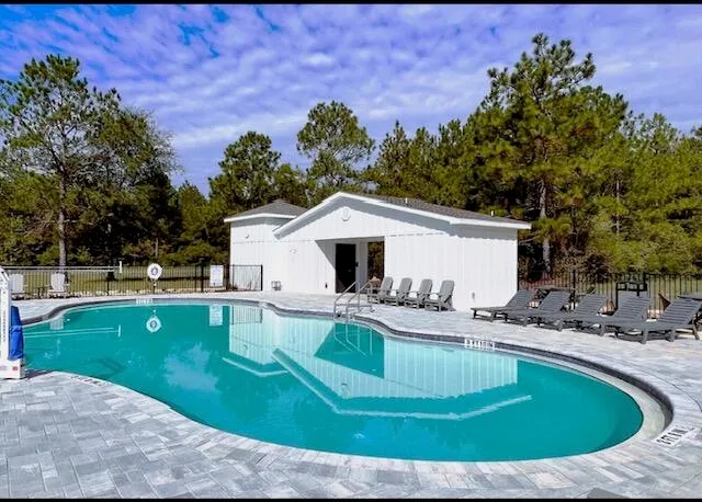 a view of a house with swimming pool and a yard
