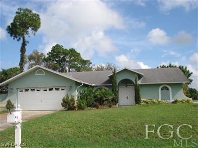 9069 Aster Road Fort Myers, FL 33967 - Photo 1 of 1 a front view of a house with a yard and garage