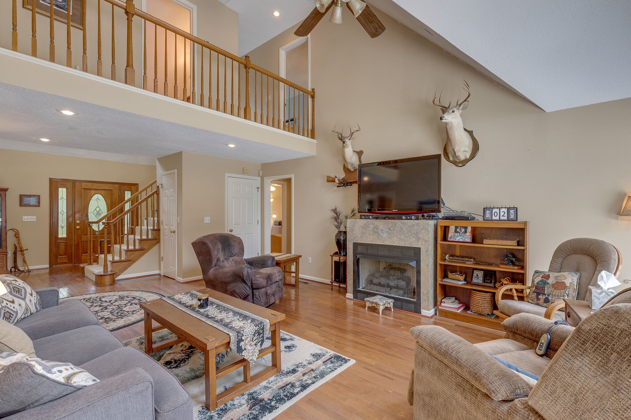2300 Lee Road Spring Hill, TN 37174 - Photo 9 of 31 a living room with furniture a fireplace and a piano