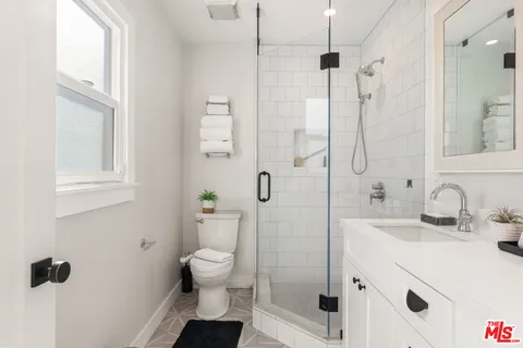 a bathroom with a sink toilet and shower