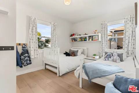 a bedroom with two beds and a window