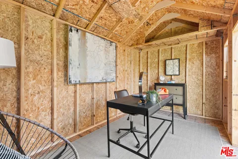 a view of a room with furniture and a window