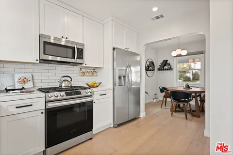 a kitchen with stainless steel appliances a stove microwave and refrigerator