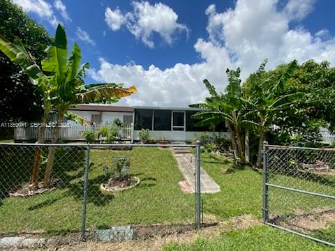 25931 Southwest 130th Avenue Homestead, FL 33032 - Photo 11 of 44 a swimming pool with outdoor seating and yard