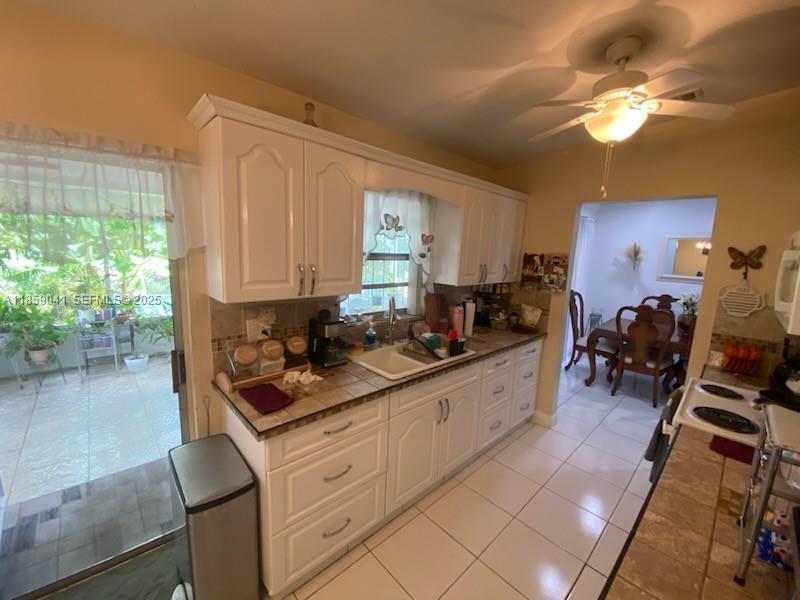 25931 Southwest 130th Avenue Homestead, FL 33032 - Photo 18 of 44 a kitchen with sink refrigerator and cabinets