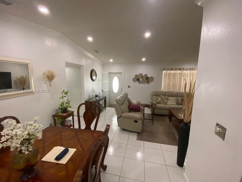 25931 Southwest 130th Avenue Homestead, FL 33032 - Photo 26 of 44 a living room with furniture and a potted plant