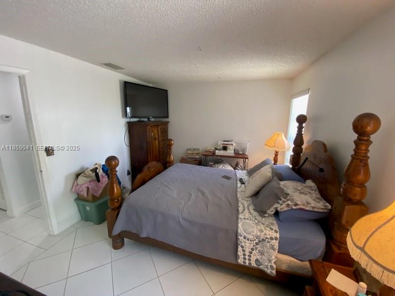 25931 Southwest 130th Avenue Homestead, FL 33032 - Photo 29 of 44 a bedroom with a bed and a tv