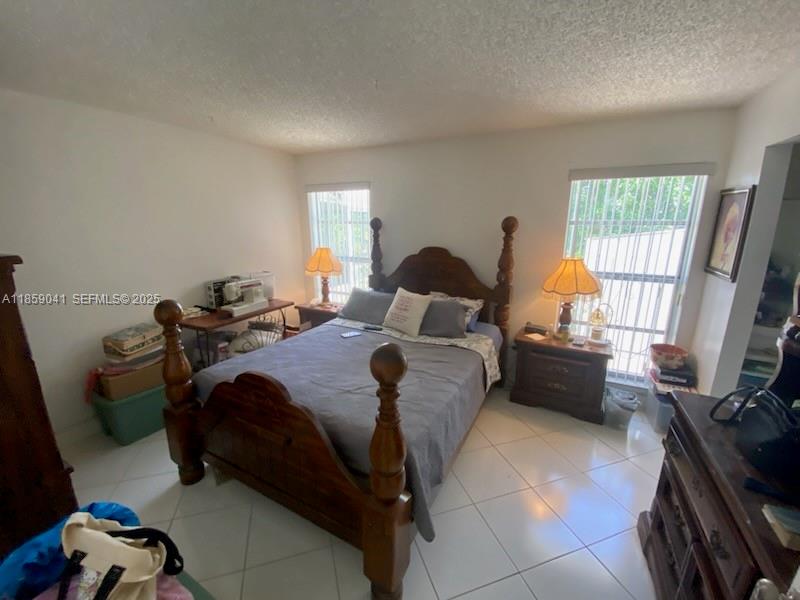 25931 Southwest 130th Avenue Homestead, FL 33032 - Photo 32 of 44 a bed room with a bed and a window