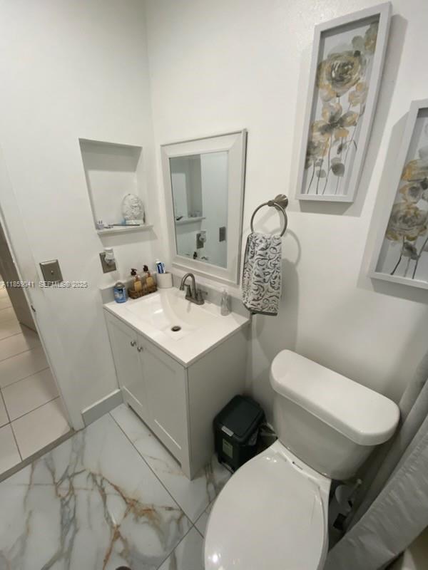 25931 Southwest 130th Avenue Homestead, FL 33032 - Photo 37 of 44 a white toilet sitting next to a bathroom sink