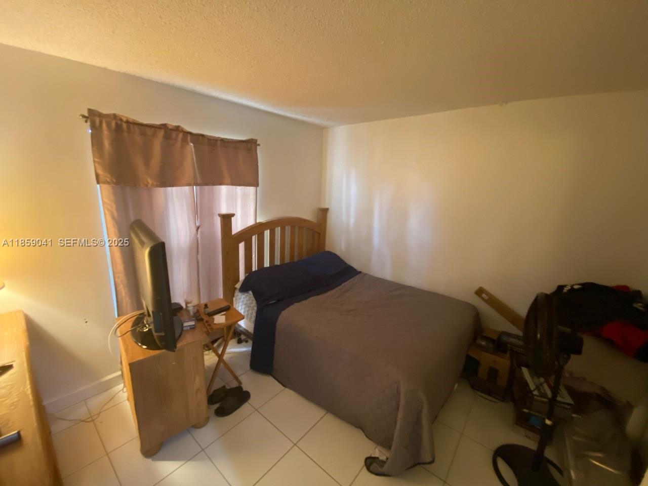 25931 Southwest 130th Avenue Homestead, FL 33032 - Photo 40 of 44 a bedroom with a bed and a mirror