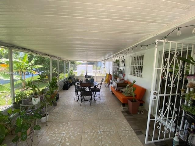 25931 Southwest 130th Avenue Homestead, FL 33032 - Photo 4 of 44 a view of a porch with table and chairs
