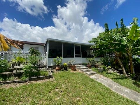 25931 Southwest 130th Avenue Homestead, FL 33032 - Photo 6 of 44 a patio with table and chairs and potted plants
