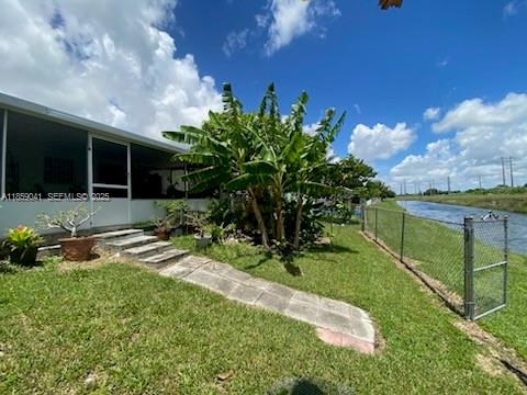 25931 Southwest 130th Avenue Homestead, FL 33032 - Photo 7 of 44 a backyard of a house with lots of green space