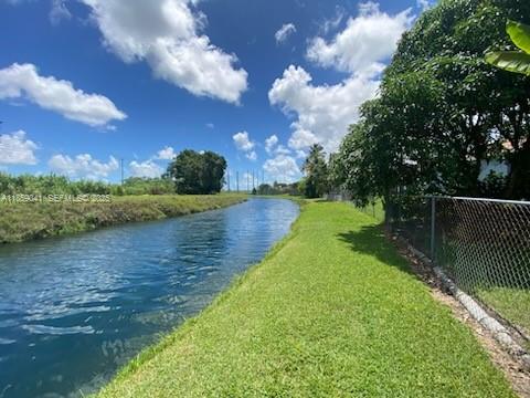 25931 Southwest 130th Avenue Homestead, FL 33032 - Photo 8 of 44 a view of a lake with a big yard