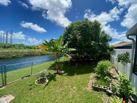 25931 Southwest 130th Avenue Homestead, FL 33032 - Photo 10 of 44 a view of a garden with a building in the background