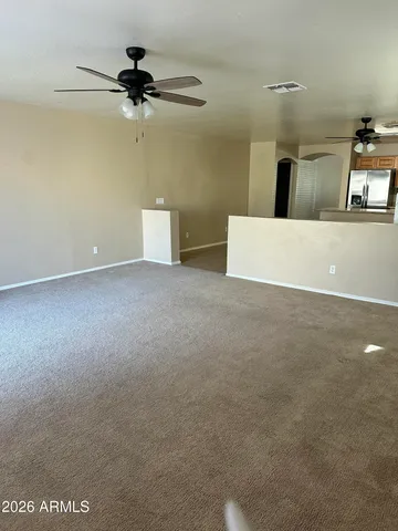 a view of a room with a ceiling fan