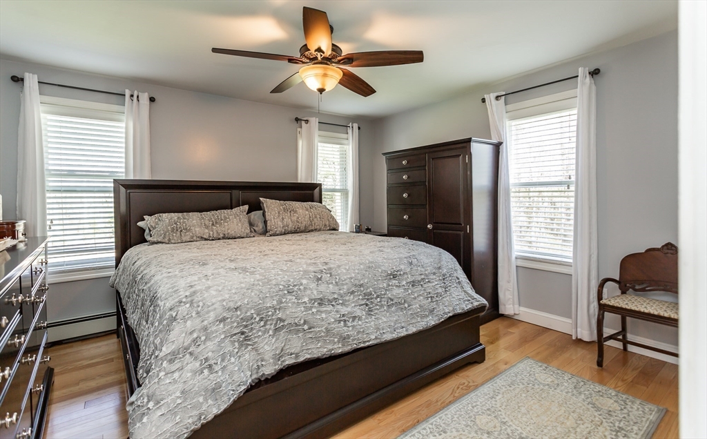 12 Elderberry Drive Acushnet, MA 02743 - Photo 14 of 41 a bedroom with a bed and a chandelier