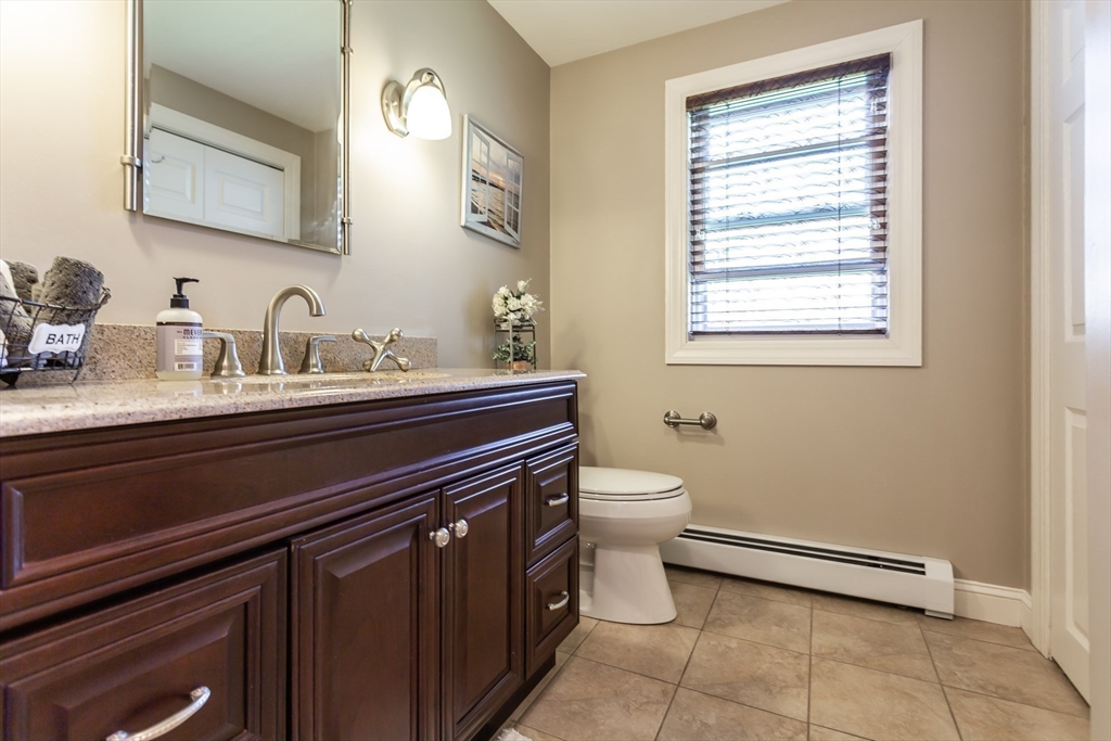 12 Elderberry Drive Acushnet, MA 02743 - Photo 18 of 41 a bathroom with a toilet sink and mirror
