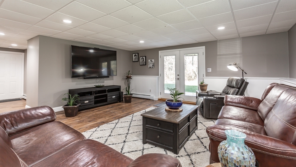 12 Elderberry Drive Acushnet, MA 02743 - Photo 31 of 41 a living room with furniture a flat screen tv and a large window
