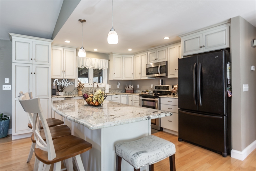 12 Elderberry Drive Acushnet, MA 02743 - Photo 4 of 41 a kitchen with a refrigerator a stove a sink and chairs