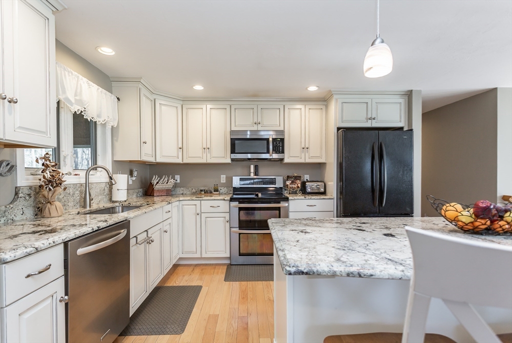 12 Elderberry Drive Acushnet, MA 02743 - Photo 7 of 41 a kitchen with stainless steel appliances granite countertop a stove refrigerator sink and microwave