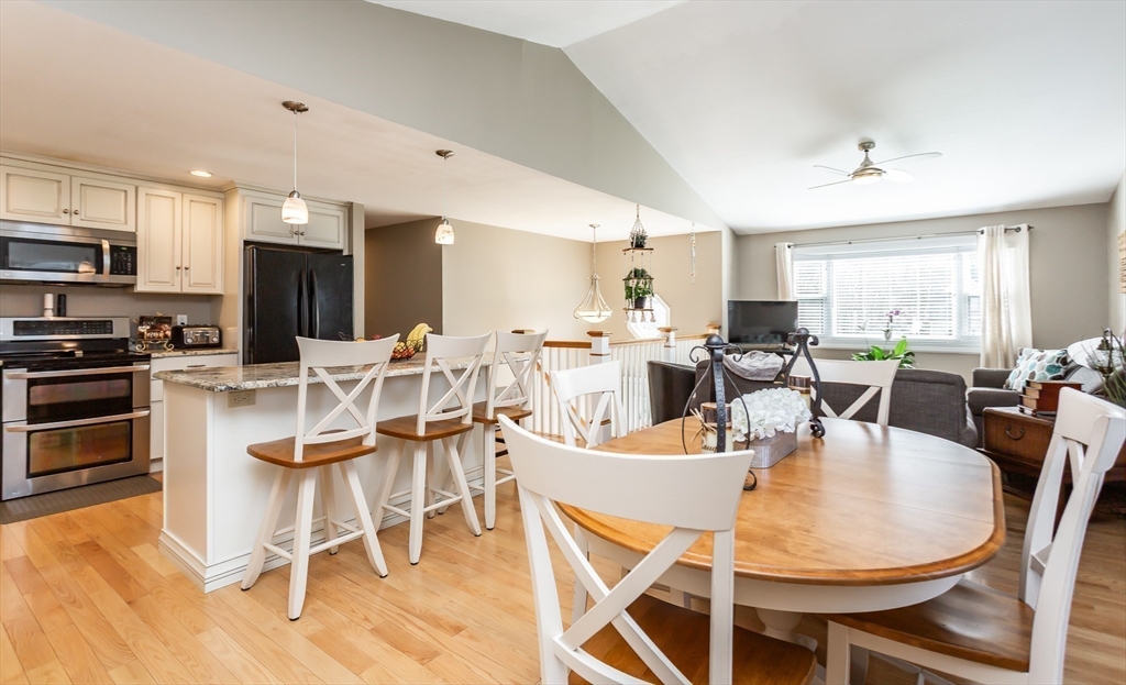 12 Elderberry Drive Acushnet, MA 02743 - Photo 10 of 41 a dining room with stainless steel appliances kitchen island granite countertop a dining table chairs and a refrigerator
