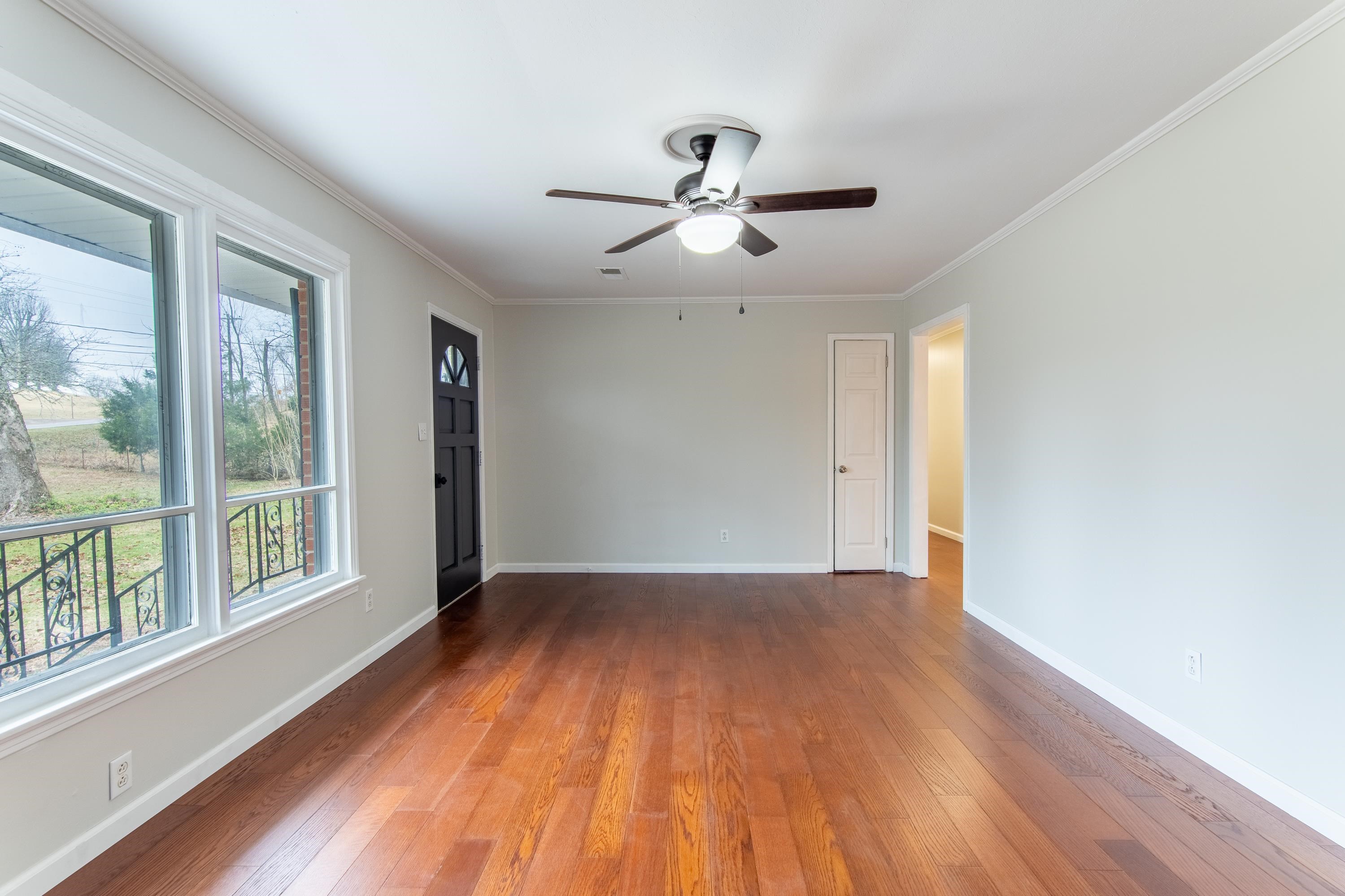 4155 Clifton Road Savannah, TN 38372 - Photo 3 of 40 Unfurnished room with crown molding, dark hardwood / wood-style floors, and ceiling fan