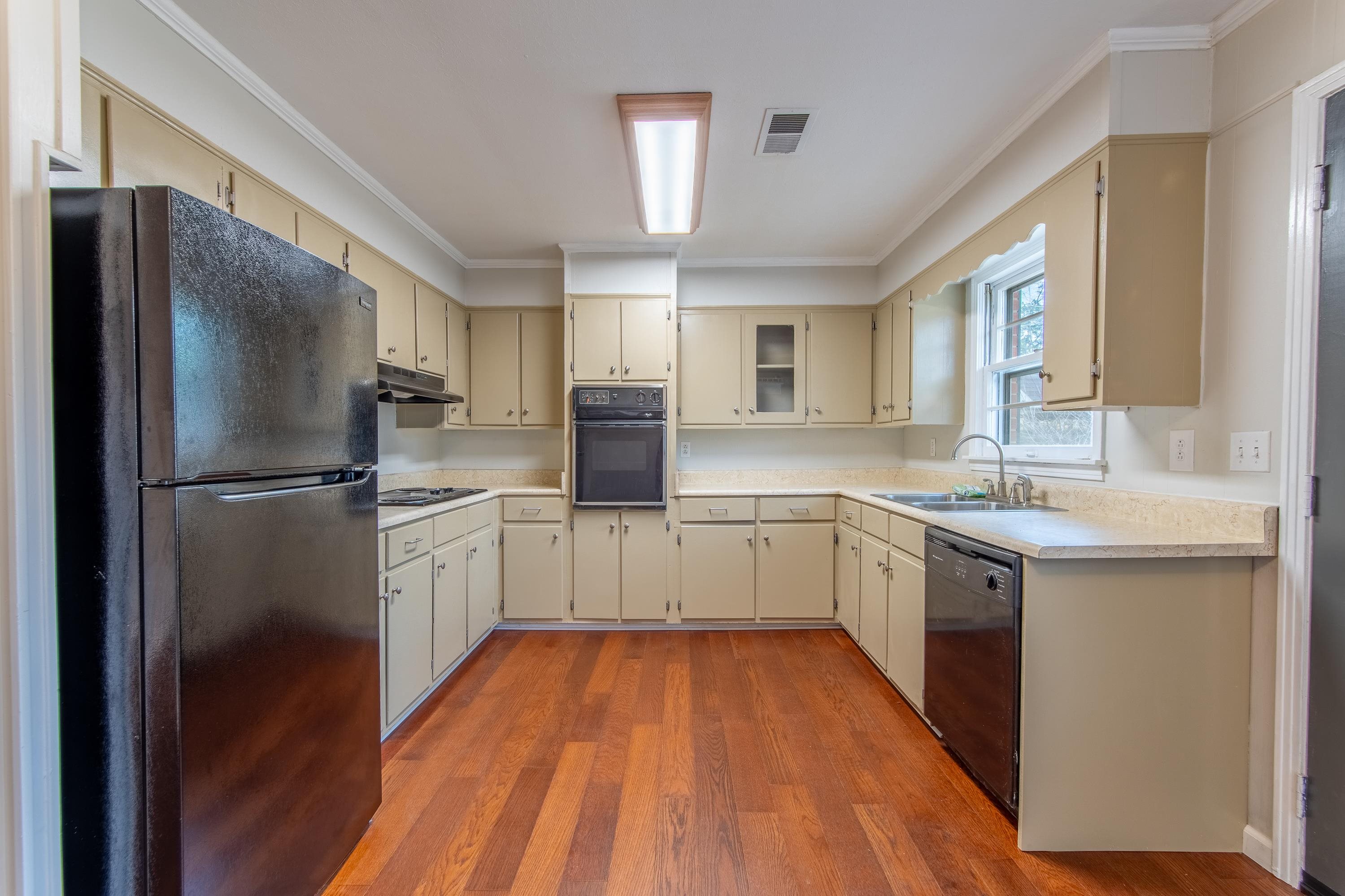 4155 Clifton Road Savannah, TN 38372 - Photo 7 of 40 Kitchen featuring cream cabinetry, sink, and black appliances