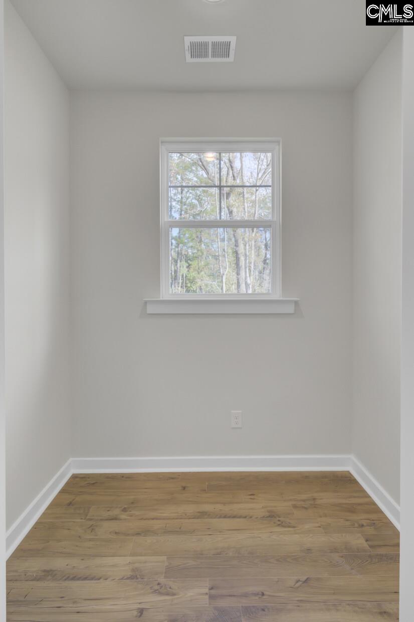 320 Brass Billion Path Lexington, SC 29073 - Photo 7 of 39 an empty room with wooden floor and windows