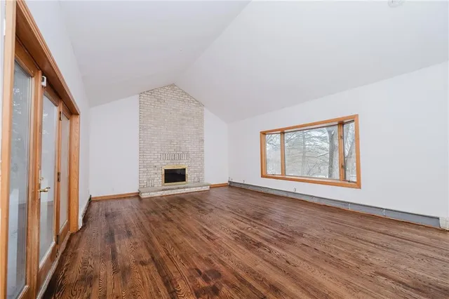 wooden floor in an empty room with a fireplace