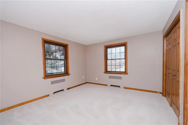 a view of an empty room and wooden door