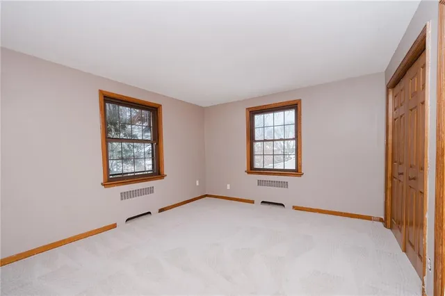 a view of an empty room and wooden door