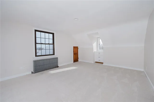 an empty room with closet and mirror