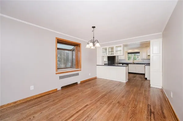 a view of a kitchen with wooden floor and a kitchen