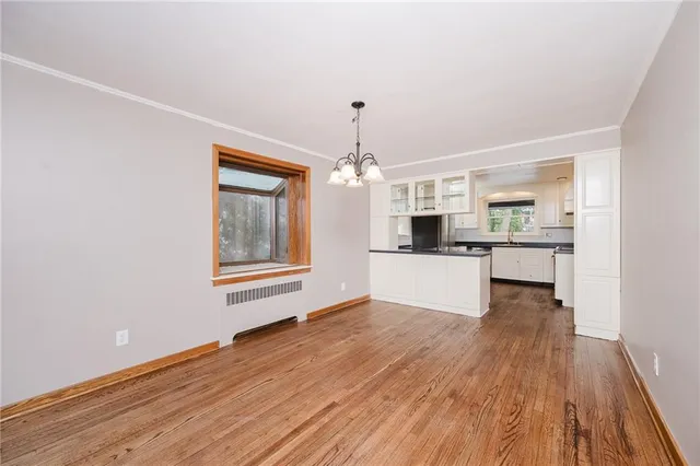 a view of a kitchen with wooden floor and a kitchen
